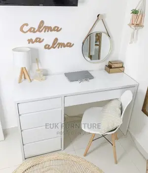 A Table With Four Drawers and a Chair