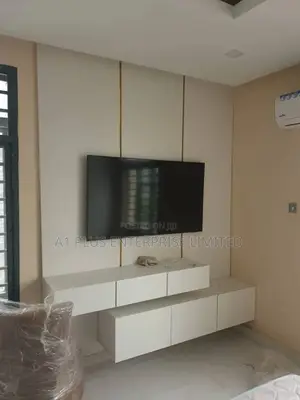 White Tv Wall Panel With 2 Step Console and Touch of Gold