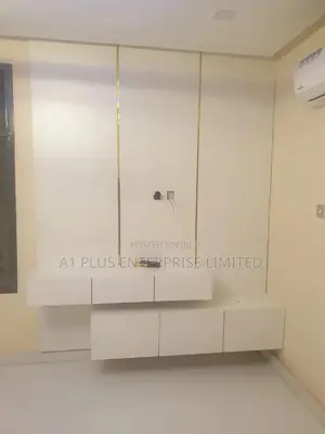 White Tv Wall Panel With 2 Step Console and Touch of Gold