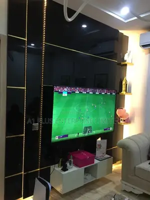 Black Tv Wall Cladding With White Console & Touch Of Gold