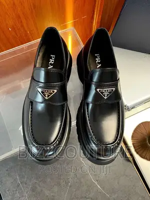 Original PRADA Logo Plaque Loafers Available in Store