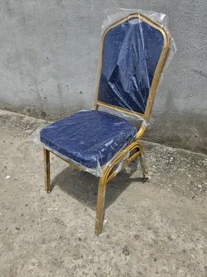 Blue Banquet Chair With Metal Legs and Iron at the Back