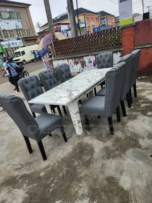8 Seaters Leather Dining Chairs and HDF Glossy Top.