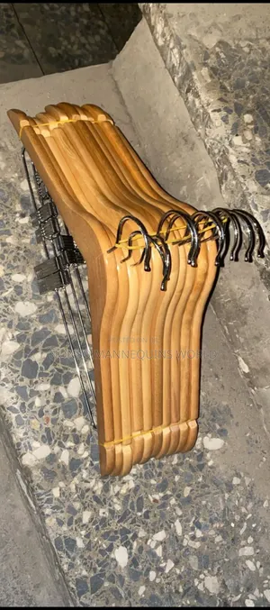 A Pack Of Wooden Hangers With Clips
