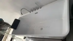 White Bathtub With Hand Shower and Tap