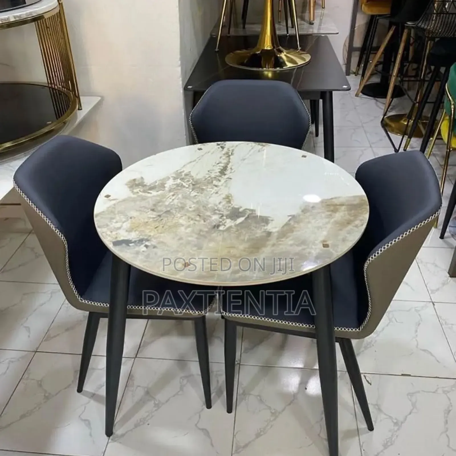 Round Marble Dining Table With Four Gray Back Chairs