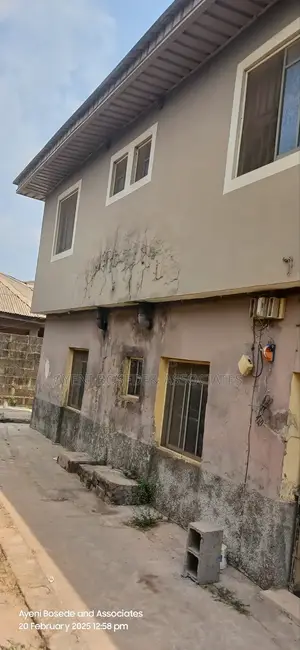 Two Buildings One Completed And The Other At Lintel Level