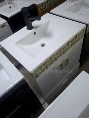 Modern White Sink Vanity With Black Faucet and Decor Accent