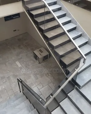 Tinted Glass Railing With Silver Pipe Handle