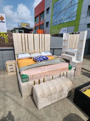 A Set of Cream Coloured Padded Bed Set.