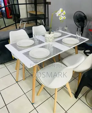 4 Seater Wooden Leg Dining Set With Leather Seats.