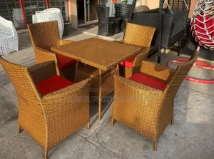 A Set of Golden Rattan Outdoor Chairs and Table