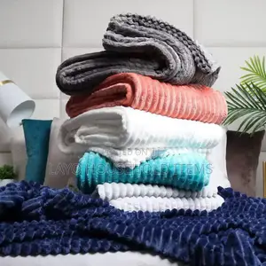 Stack of Folded Fleece Blankets in Various Colors