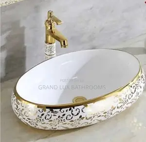 Elegant Gold-Trimmed Ceramic Wash Basin With Ornate Floral D