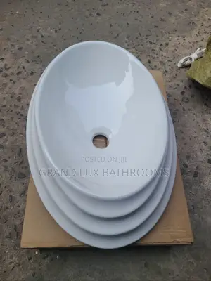 **Modern Oval Ceramic Countertop Basin – Tiered Rim Design**