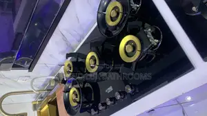 A Modern Black Gas Hob With Five Gold-Accented Burners