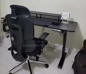 Sit-Stand Adjustable Gaming Desk and Chair.