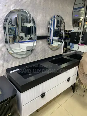 **Modern Double Sink Vanity With Oval Mirrors and Textured Wall Finish