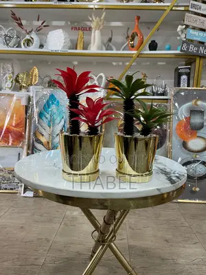 Faux Flower in a Gold Ceramic Vase