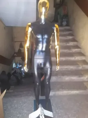 Faceless Black And Gold Male. Mannequin