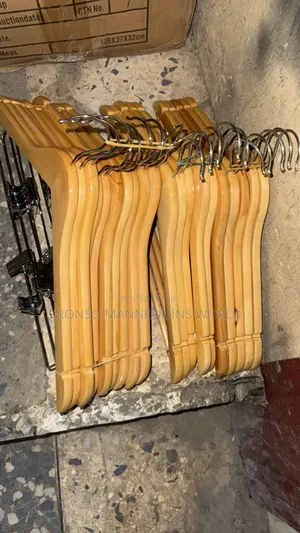 A Pack Of Wooden Hangers With Clips
