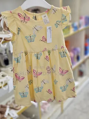 H M Printed Cotton Dress in Yellow With a Butterfly Print.
