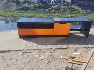 High Quality Modern Black and Orange Tv Stand With a Glossy Finish.