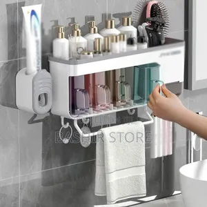 Wall-Mounted Bathroom Organizer That Includes a Toothbrush Holder