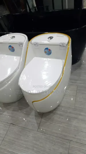 Modern One-Piece Toilet With Gold Trim – Luxury Sleek Design