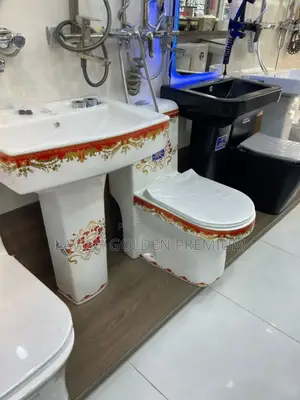 Water Closet With a Decorative Red and Gold Pattern.