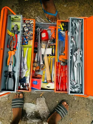 Orange, Multi-tiered Toolbox Filled With A Variety Of Hand Tools.