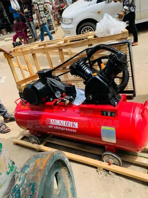 Mark Air Compressor. It Appears to Be a Large, Red,