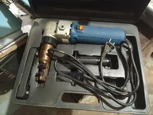 Electric Metal Nibbler, Which Is a Power Tool Cutting Sheet Metal.