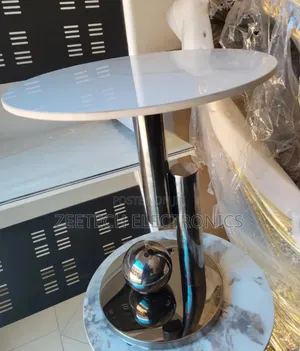 Round Side Table With a White Marble Top and a Polished Stainless Stee