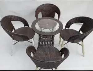Brown Rattan Outdoor Patio Table and Four Chairs Set.