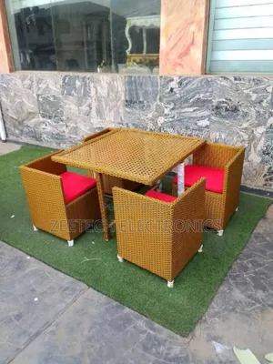 Four-Seater Outdoor Rattan Dining Set With Red Cushions.