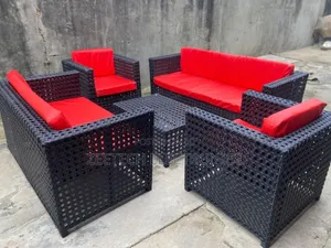 Standard Ratten Wicker Outdoor Sofa Set With Red Cushions.