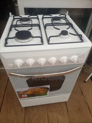 This Is a White Freestanding Gas Stove and Oven With a Glass Top