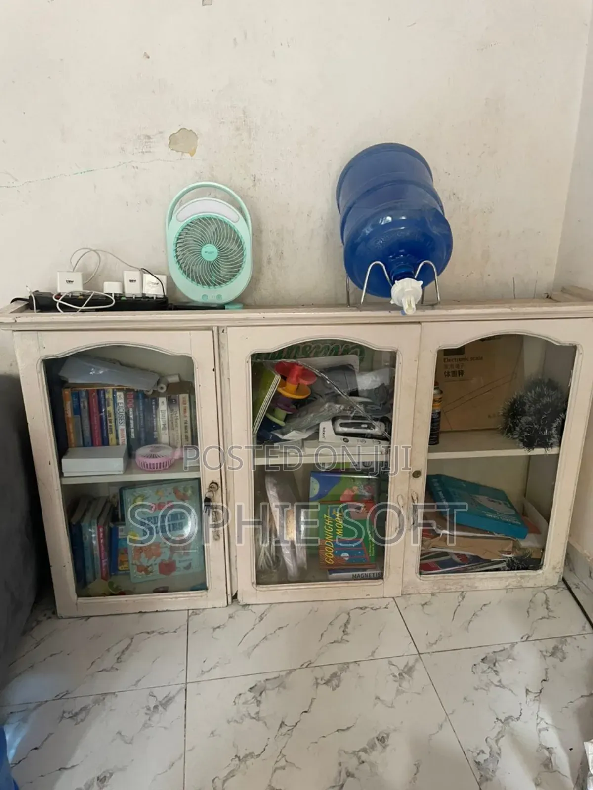 A White Multipurpose Shelf With Glasses