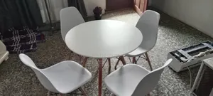 White Round Table and Four Matching Chairs With Wooden Legs