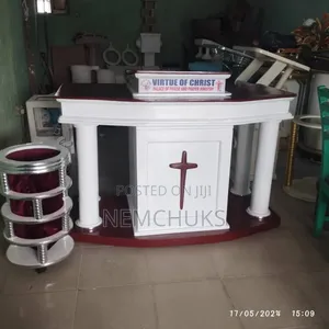 Modern Church Pulpit With Pillar Support and a Prominent Cross Emblem