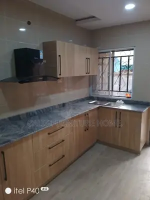 L - Shape Kitchen Cabinets Brown Color.