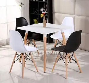 Dining Table Set With White and Black Modern Chairs and a White Table