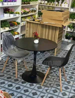 Dining Set Features a Tulip-Style Table Base and Two Eames Chairs.