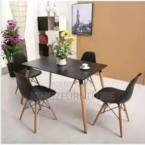 A Black Rectangular Tabletop and Four Matching Chairs