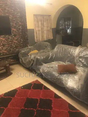 Neatly Used L Shaped Cushion With One Single and Center Table