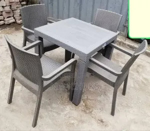 A Synthetic Rattan-Style Plastic Outdoor Dining Set