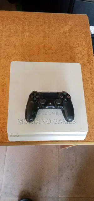 U K Used Sony Ps4 Slim With Two Pads and 10 Games Inside