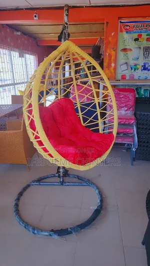 Light Yellow Swinging Chair With Red Cushion