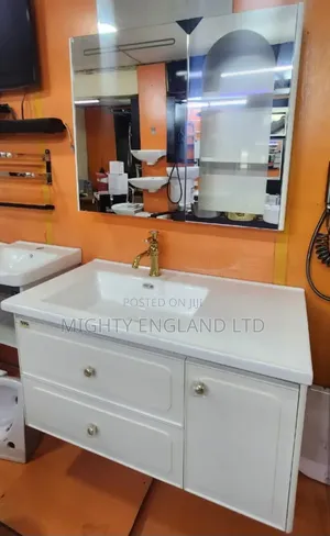 Wall-Mount Bathroom Cabinet With Ceramic Sink a Gold-Colored Faucet